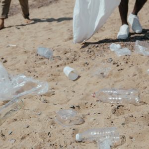 plastic bottles and plastic bags on sand