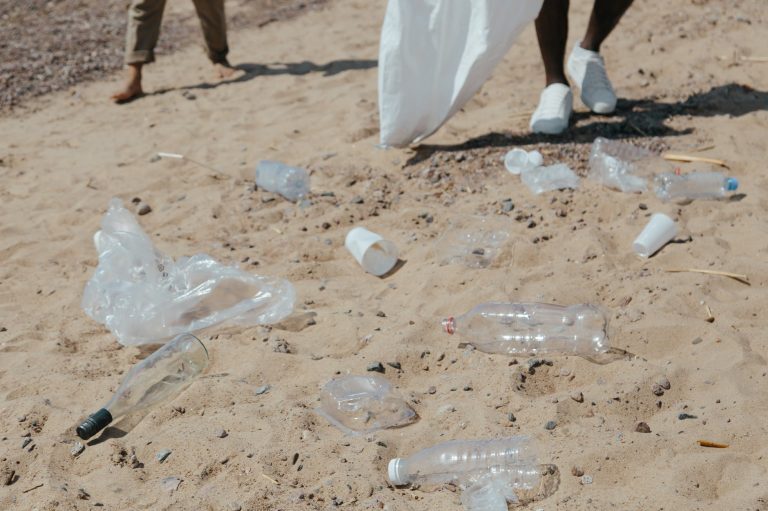 plastic bottles and plastic bags on sand