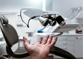 person showing magnifying eyeglasses