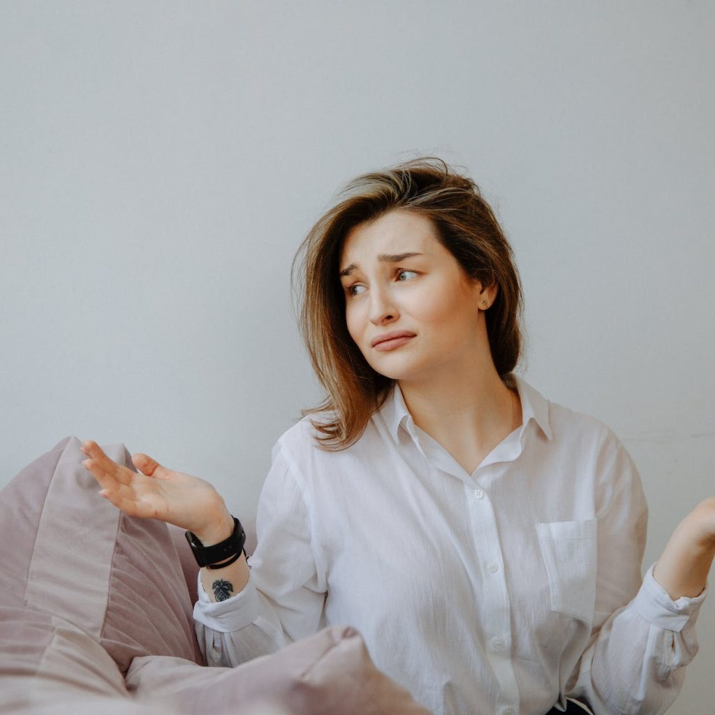 clueless woman in white dress shirt