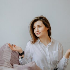 clueless woman in white dress shirt