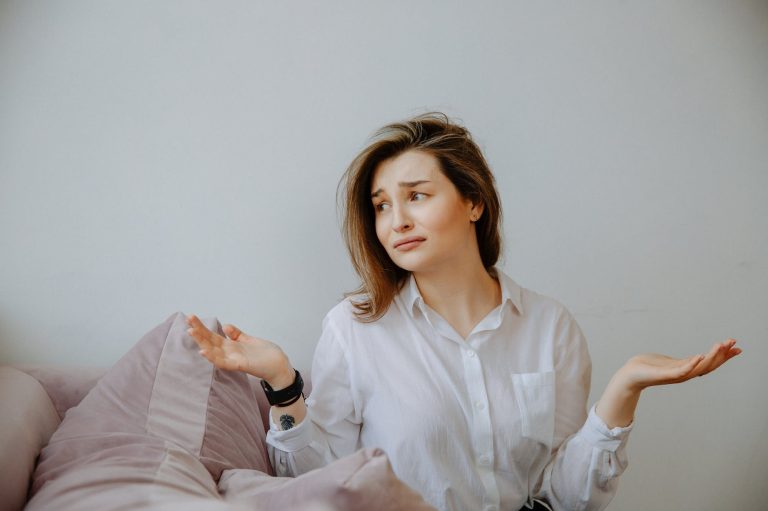 clueless woman in white dress shirt