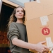 young woman with boxes while moving out of old home