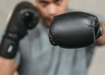 strong ethnic fighter showing punching technique during training