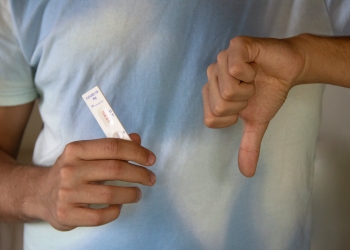 a person holding an antigen rapid test result