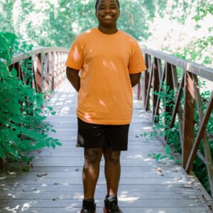 a boy standing on footbridge