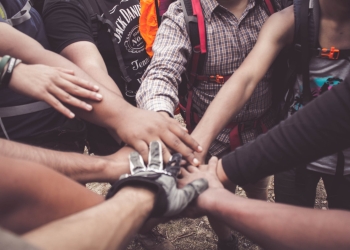 people doing group hand cheer