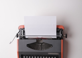 writer working on typewriter in office