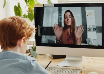 photo of boy video calling with a woman through imac