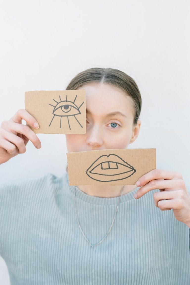 woman holding cardboard pieces with drawings