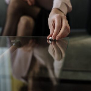 person in white long sleeve shirt holding silver and black scissors