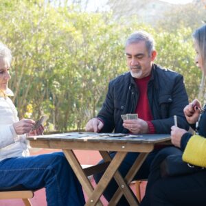 elderly people playing cards
