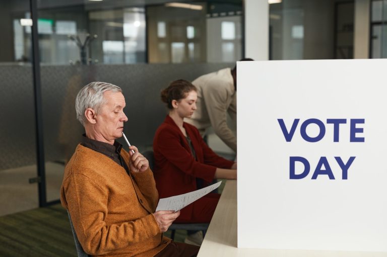 a man reading his vote ballot