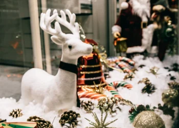 shop showcase festive decorations with shiny baubles and santa figurine