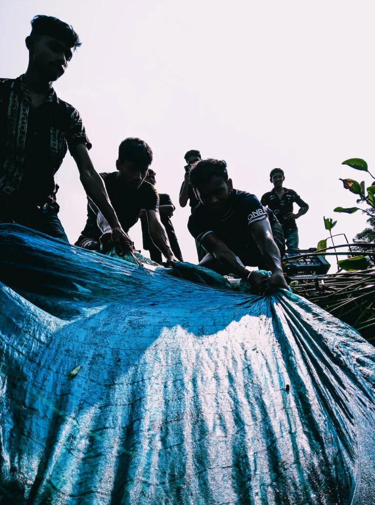 young men pulling tarp