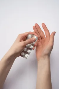 person holding silver blister pack