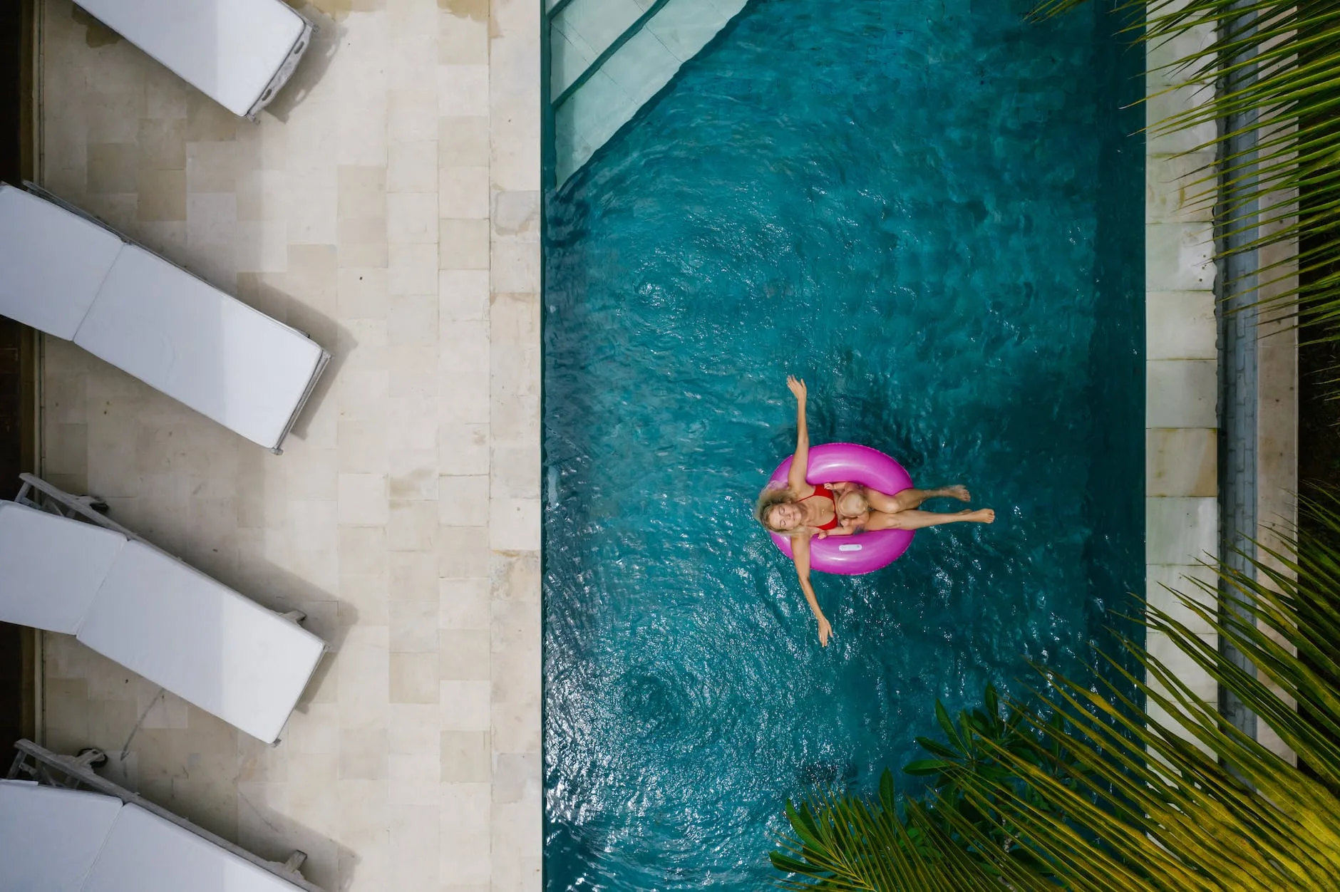 a woman in red bikini chilling on pool