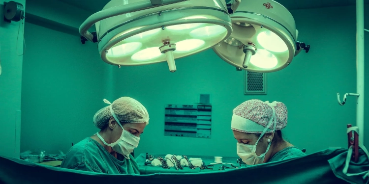 two person doing surgery inside room