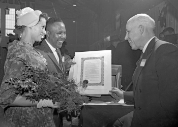 Doris and Bob Turner looking at an award he received for his work in 1960.