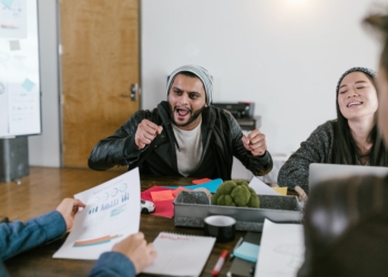 woman in black jacket sitting beside woman in gray sweater