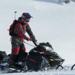 Person riding a snowmobile.