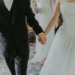 woman wearing white wedding gown holding hands with man while walking