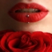 woman wearing red lipstick near red rose