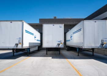 three white enclosed trailers