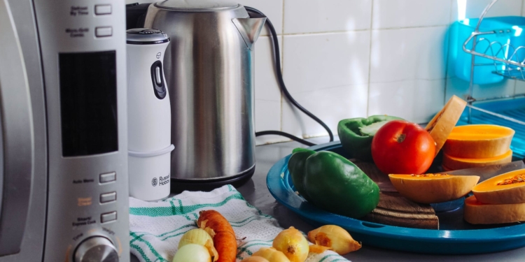 photo of vegetables beside gray electric kettle