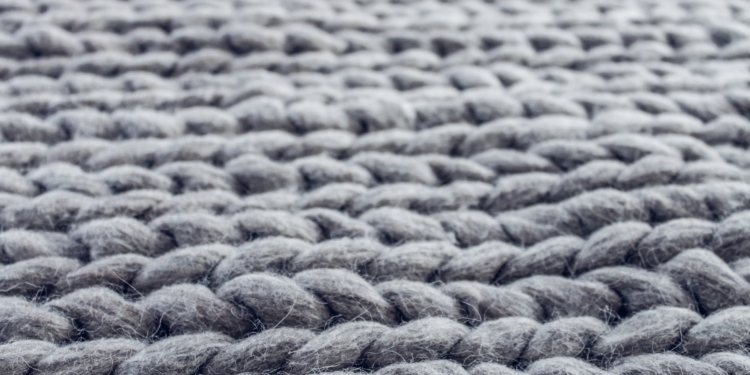 close up of gray cable knit cloth