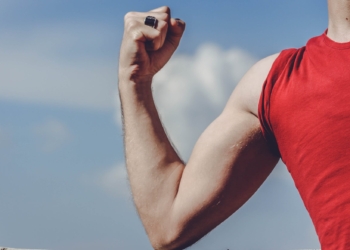 man raising his right arm