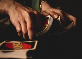 person shuffling uno cards