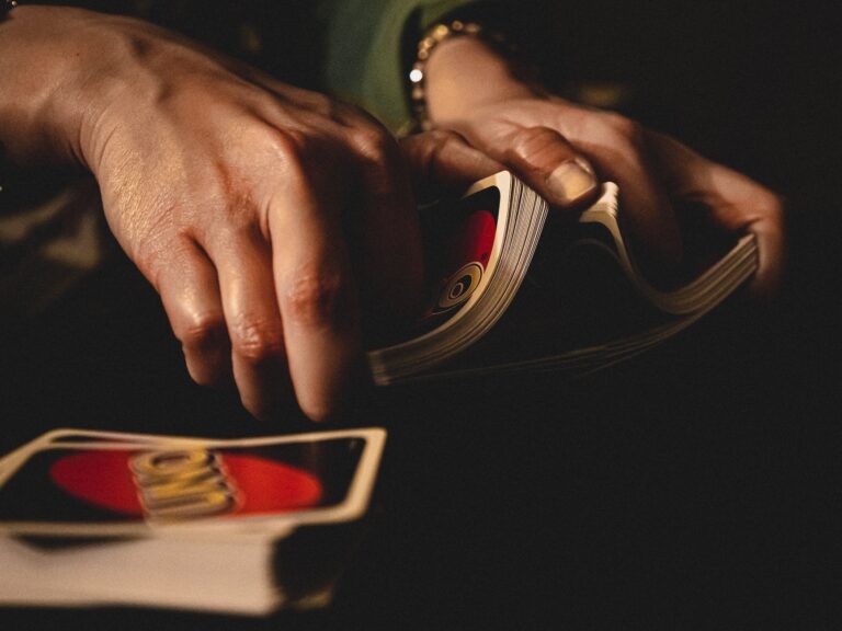 person shuffling uno cards
