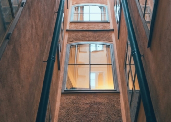 old multistage building facade with drain pipes in town