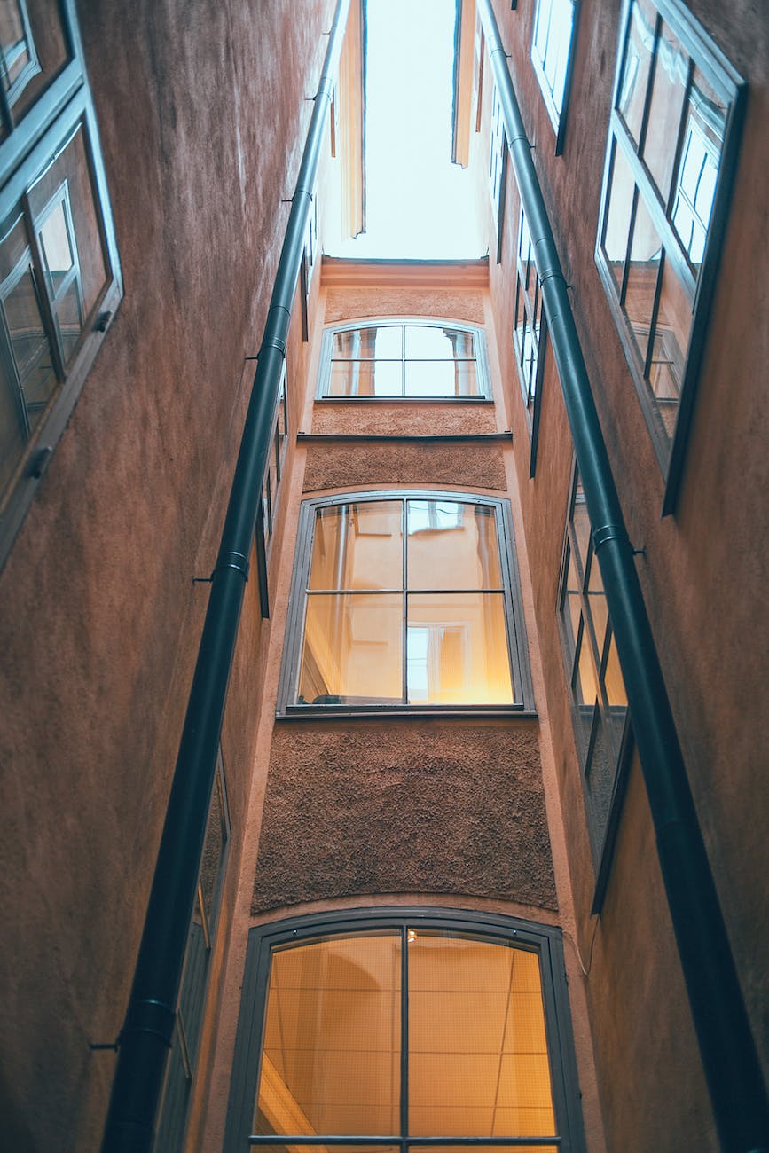 old multistage building facade with drain pipes in town