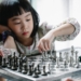 pensive asian girl playing chess