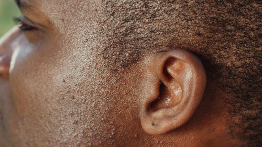 man s ear in close up photography