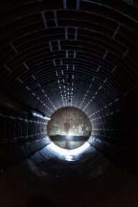 a dark tunnel with a light at the end