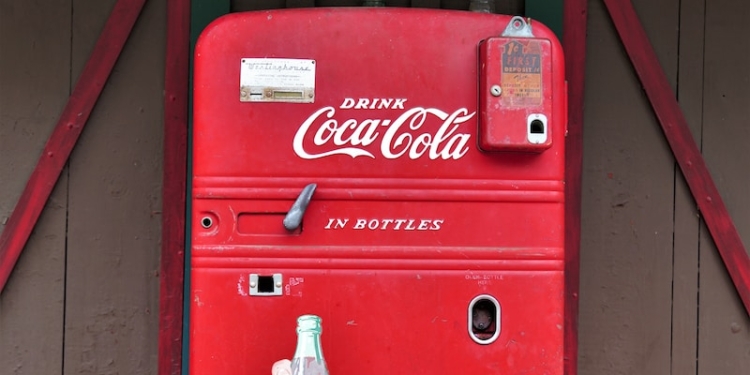 coca cola soda bottle on red coca cola vending machine