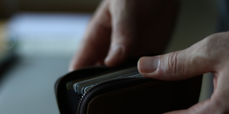 a person holding a wallet in their hand