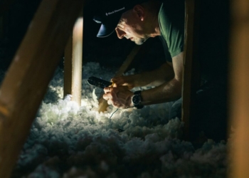 man in green crew neck t-shirt holding smoking pipe