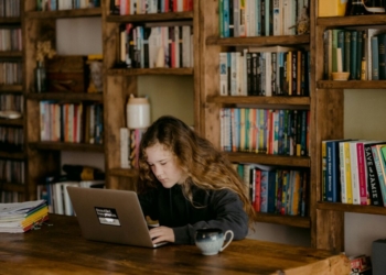 woman in black long sleeve shirt using macbook