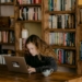 woman in black long sleeve shirt using macbook