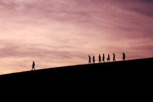 silhouette of people on hill