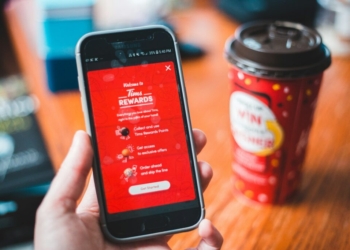 a person holding a cell phone in their hand