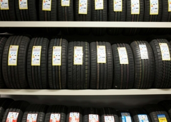 black leather belt on white wooden shelf