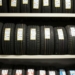 black leather belt on white wooden shelf