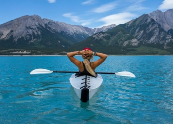 woman riding kayak at the middle of the sea