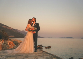 man and woman standing on brown concrete dock during daytime