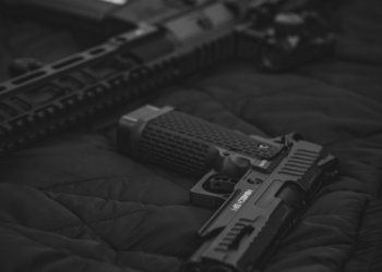 black semi automatic pistol on black textile